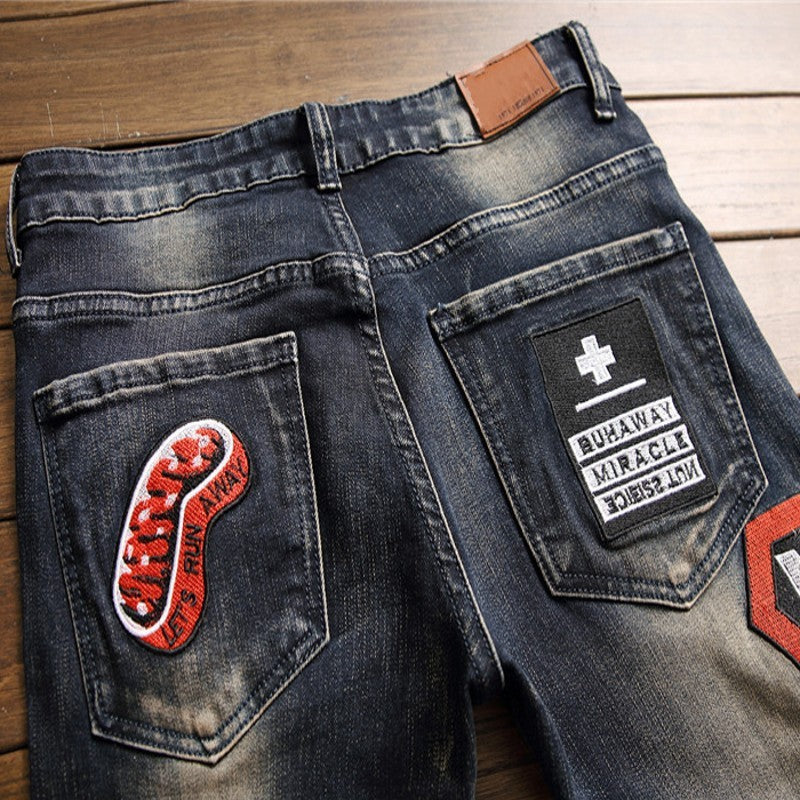 Andrew – Jeans Déchirées avec Patch Écusson